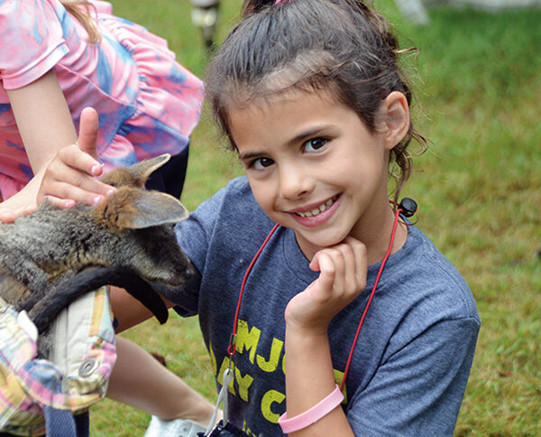 girl petting a goat